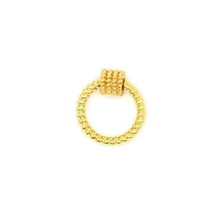 Detailed close-up of a gold rope-textured metal ring with a cylindrical bead charm