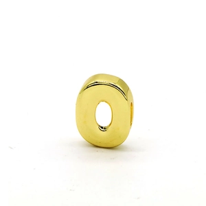 Close-up of polished gold letter O charm bead with a center hole for DIY bracelet making