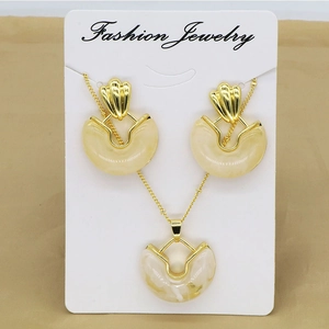Vintage geometric heart necklace and earrings set with amber resin in gold frames