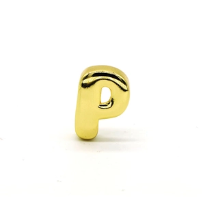Macro shot of polished gold 3D bubble letter P charm with glossy metallic finish