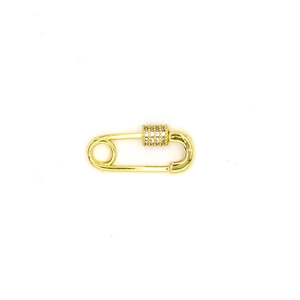 Macro detail of gold safety pin jewelry clasp with crystal pavé cylinder charm