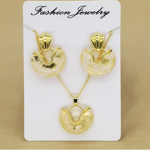 Close-up of golden geometric jewelry set with marble resin on white display card