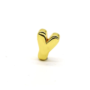 Macro shot of 3D polished gold letter Y pendant with reflective mirror finish surface