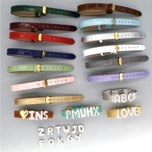 Detail of colorful crocodile texture straps with customizable shiny crystal letter sliders