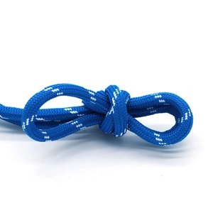 Detail of blue braided rope bracelet with white dotted patterns and durable knots