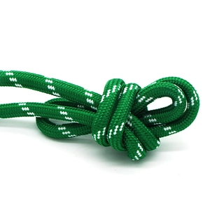 Detail of green and white woven rope with flexible braided pattern and secure knot