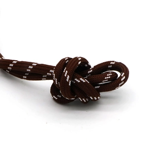 Detailed macro view of deep brown braided cord with reflective white dotted pattern texture