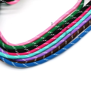 Detailed view of eight colorful braided rope cords with white dotted patterns for bracelets