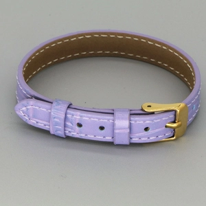 Detailed shot of purple crocodile pattern leather strap with white stitching and gold buckle