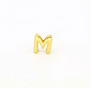 Close-up of golden letter M charm with polished finish for DIY jewelry bracelet