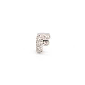 Macro shot of silver letter F charm with pave-set cubic zirconia for DIY jewelry