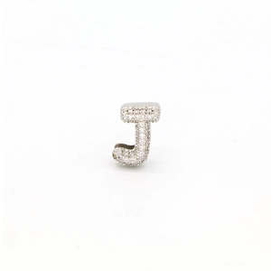 Macro shot of silver letter J pendant with micro-pave cubic zirconia stones