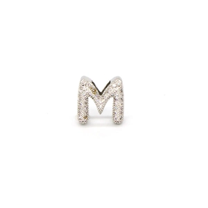 Macro shot of silver letter M charm with pave-set cubic zirconia for DIY bracelets