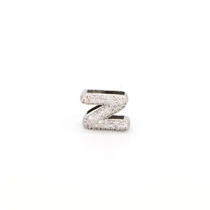 Detailed macro view of silver letter Z charm with cubic zirconia for DIY bracelets