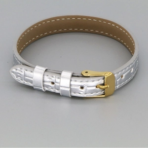 Detail of crocodile embossed silver leather strap with gold buckle and fine stitching