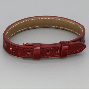 Detailed macro view of dark red leather bracelet with white contrast stitching and texture