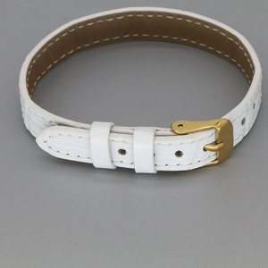 Detail view of white crocodile pattern leather strap with golden metal buckle clasp