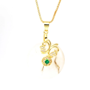Macro shot of 925 silver butterfly pendant with green gemstone and zircon inlays