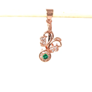 Macro view of 925 silver flower pendant clasp with green gemstone and rose gold finish