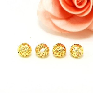 Detail of four 18k gold plated hollow mesh round beads for DIY jewelry making