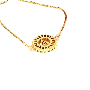 Detail of adjustable gold box chain bracelet with sparkling zircon letter A pendant