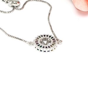 Close-up of silver letter V pendant bracelet with colorful zircon and adjustable chain
