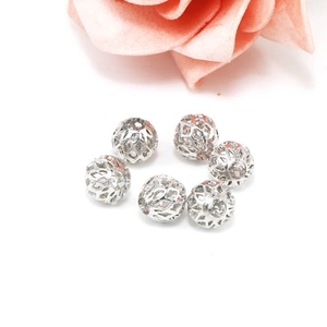 Detail of six hollow mesh silver round beads for DIY handmade jewelry accessories