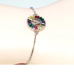 Macro view of silver letter V bracelet featuring colorful zircon stones on the wrist