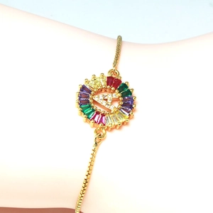 Golden adjustable bracelet with rainbow zircon pendant and crystal letter A detail