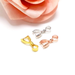 Detailed view of silver and gold plated jewelry clasp clips for necklace pendants