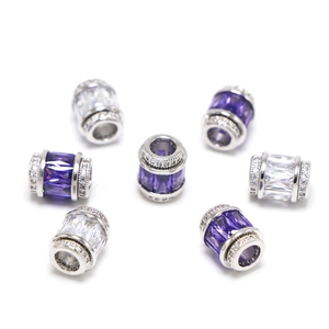Vue macro de breloques en argent 925 avec zircons violets et clairs en disposition circulaire