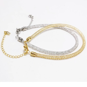 Detail of gold and silver mesh bracelets with sparkling crystals and lobster clasp