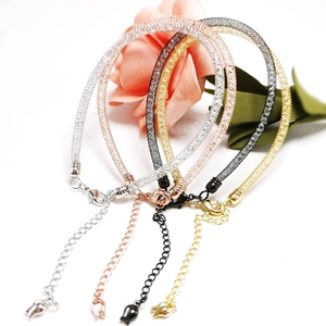 Detail of mesh tube bracelets in four colors with crystal fillings and tulip charms