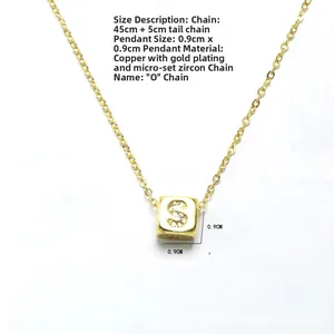 Detail of gold cube pendant with letter S and white zircon on a 45cm chain necklace