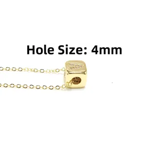 Detail of gold alphabet necklace showing 4mm hole size and sparkling letter A pendant