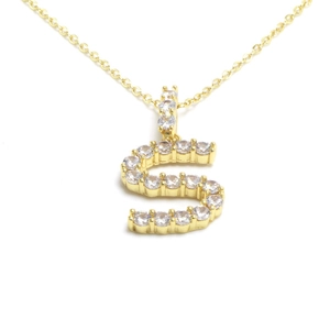 Detail of gold letter S pendant encrusted with sparkling crystals on fine O-chain