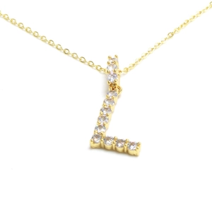Detailed view of gold letter L pendant necklace with brilliant crystal stone settings