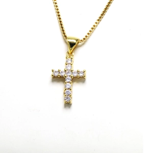 Detailed view of gold cross pendant with 11 round cubic zirconia on box chain