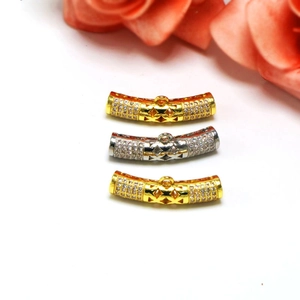 Macro shot of gold and silver plated tube spacers with zircon micro-paving for DIY jewelry
