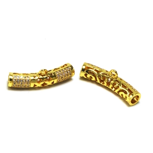 Macro detail of gold-plated hollow curved tube beads with pavé zircon for DIY jewelry