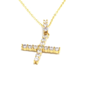 Close-up of golden necklace with a cross pendant paved in sparkling cubic zirconia crystals