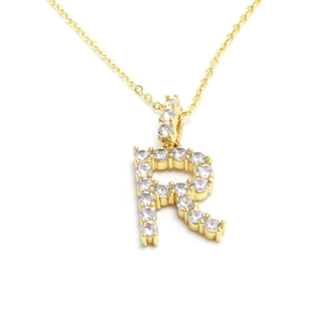 Close-up of golden letter R pendant necklace with sparkling white zircon micro-pave setting