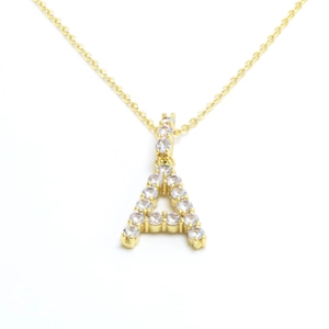 Detailed close-up of a gold letter A pendant with sparkling pave zircon on a chain