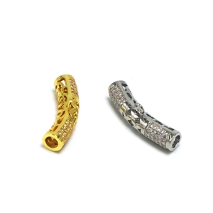 Macro detail of gold and silver curved spacer beads with hollow design and inlaid zircons