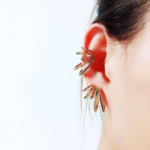 Close-up of rainbow zircon ear cuff and hoop earrings set on female ear model