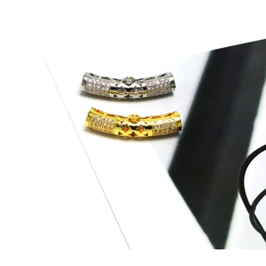 Close-up of gold and silver plated tube connectors with micro-paved zircons for jewelry