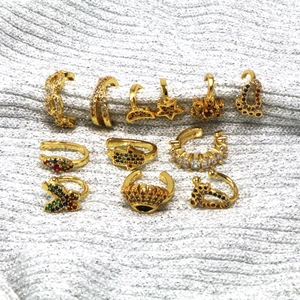 Set of 10 gold-plated ear cuffs with star, moon, and hamsa motifs and colorful zircons