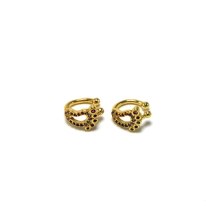 Detail of foot-shaped gold ear cuffs with five colorful circular zircon stones
