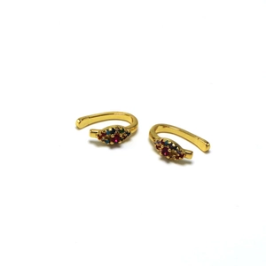 Detailed shot of golden ear cuffs with colorful marquise-shaped zircon inlays