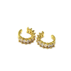 Close-up of gold C-shaped ear cuffs featuring rectangular channel-set zircons on white